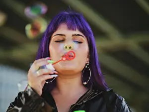 Chic Prints: Fashion woman with purple hair smiling