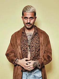 Macho Prints: Fashionable male model with tattoos wearing trendy coat over leopard shirt