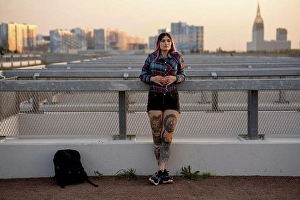 20 To 25 Years Prints: Fashionable woman day dreaming while leaning on railing at rooftop during sunset