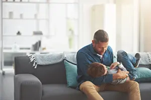 Games Prints: Father, boy and tickle kid on sofa together in home