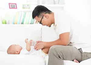 Leben Prints: Father changing diaper and clothes for baby