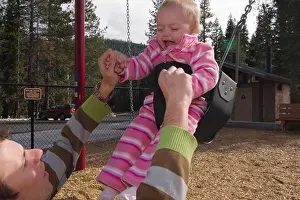 Freetime Prints: A father and child swinging in a playground near Squaw Valley California