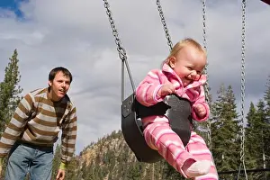 Freetime Prints: A father and child swinging in a playground near Squaw Valley California