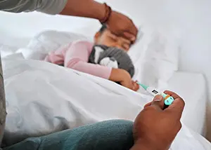 Fever Prints: Father, child and thermometer for symptoms of fever