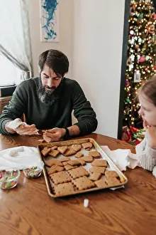Concentrate Prints: Father and daughter work together to build gingerbread house