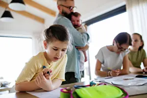 Father Prints: Father helping his daughters with homework while taking care of baby