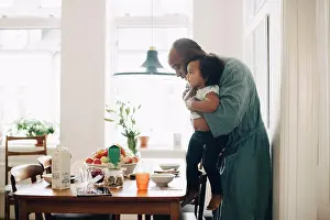 Worked Prints: Father making daughter sit at table for breakfast in dining room