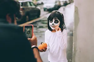 Trick Or Treat Prints: Father photographing daughter at Halloween