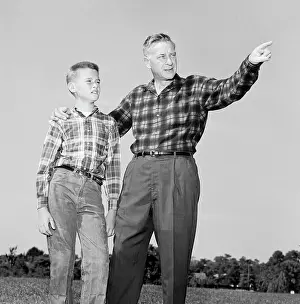 Guidance Prints: Father and son standing on lawn and looking up