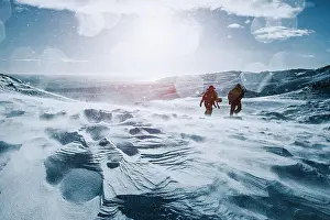 Midadult Men Prints: Father and son walking along sunny, snow covered mountain, Reykjadalur, Iceland
