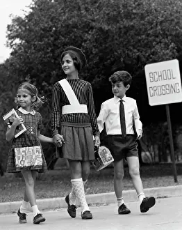Skirt Prints: Female crossing guard assisting a boy and girl at road crossing