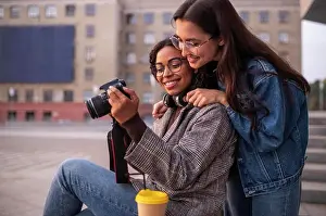 Diverse Prints: female friends having fun together with camera