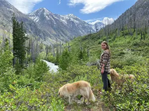 Gradeschooler Prints: Female hiking with dogs through a river valley in The North Cascades