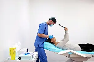 Curiosity Prints: Female patient looking herself in the mirror, lying on the stretcher