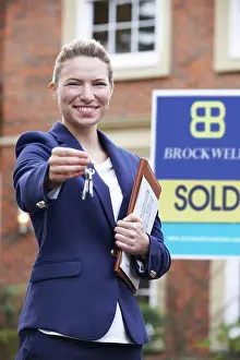 Property Prints: Female Realtor Standing Outside Residential Property Holding Keys