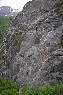 Difficult Prints: Female rock climber belaying and man climbing on Sloppy Peach above the Wosnesenki River