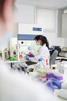 Innovation Prints: Female scientist in face mask working in laboratory