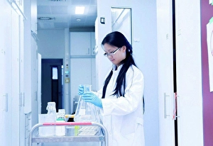 Orient Prints: Female scientist preparing experiment equipment for trolley in laboratory