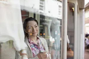 Coffee Break Prints: Female shop owner drinking tea at shop window