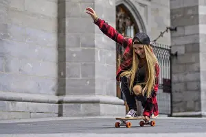 Skateboard Prints: Female skateboarder balancing herself on skateboard rolling arou