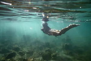 Body Of Water Prints: female swimming away from camera and up to surface of shallow ocean