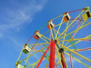 Somerset Prints: A ferris wheel at a funfair against a blue sky