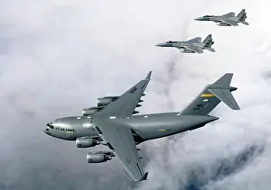 On The Move Prints: Two fighter planes escorting a C-17 Globemaster III, F-15B Eagle, US Air Force