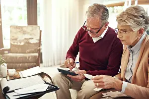 Finance, calculator and budget with an old couple in their home for retirement or pension planning