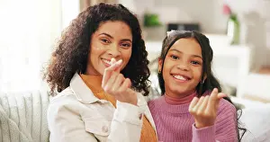 Fingers Prints: Finger heart, portrait and woman with daughter on sofa in living room of home for gratitude or love