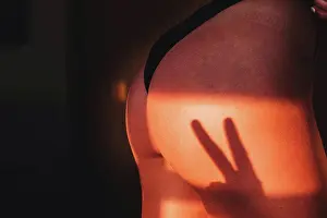 Fingers Prints: two finger shadow cast on a woman's ass