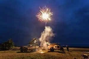 Celebrate Prints: Fireworks go off above a beach with camping trailer and camp truck