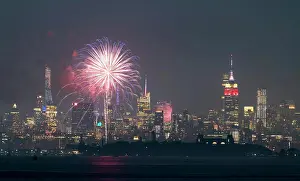 Hudson Prints: Fireworks are being set off from barges on the river between Jersey City and New York