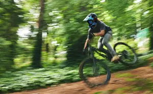 Biking Prints: Fitness, adrenaline and man doing stunt on bike while riding fast for competition practice in woods