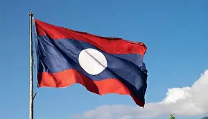 Symbolic Pictures Prints: The flag of Laos flutters in the wind, isolated against a blue sky