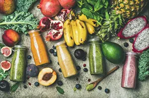 Breakfast Prints: Flat-lay of colorful smoothies in bottles with fresh tropical fruit and superfoods on concrete background