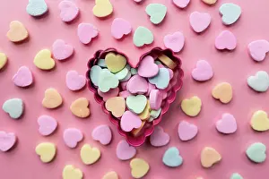 Candy Prints: flat lay of a pile of candy hearts against a pink background