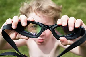 Out Of Focus Prints: Out of Focus Little Boy Looks Through In Focus Pair of Goggles