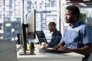 Paperwork Prints: Focused employee analyzing datasets