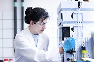 Analysis Prints: A focused scientist operating laboratory equipment
