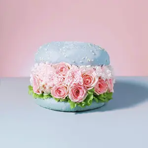 : food vegan burgers with flowers on pink background