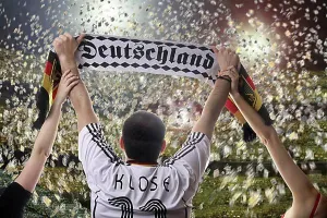 Share Prints: Football fan holding up a German supporters scarf