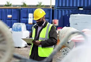 50 54 Years Prints: Foreman with clipboard at construction site