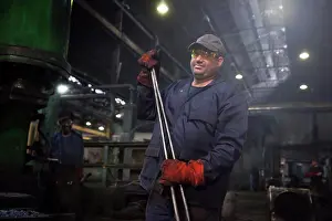 Hard Work Prints: Forge worker primed for action with a set of industrial tongs