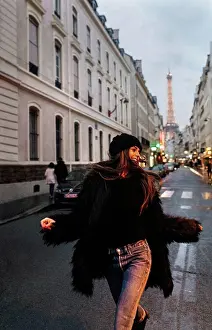 Lighted Prints: France, Paris, young woman on the street with the Eiffel Tower in the background