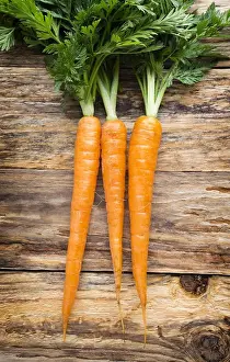 Gourmet Prints: Fresh carrots on the wooden background