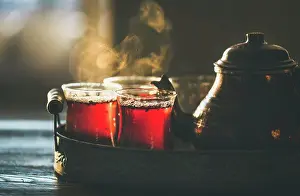 Oriental Prints: Freshly brewed black tea in turkish glasses and teapot in oriental tray, selective focus