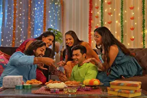 Cards Prints: Friends playing cards together at home during Diwali celebration