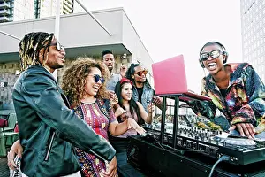 Medium Group Prints: Friends smiling with DJ on urban rooftop