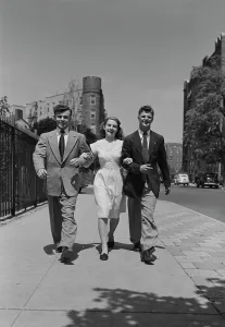 Smart Prints: Three friends walking arm in arm in street
