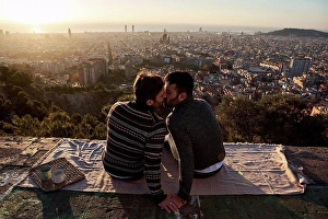 Front Of House Prints: Gay men kissing while sitting on observation point against cityscape